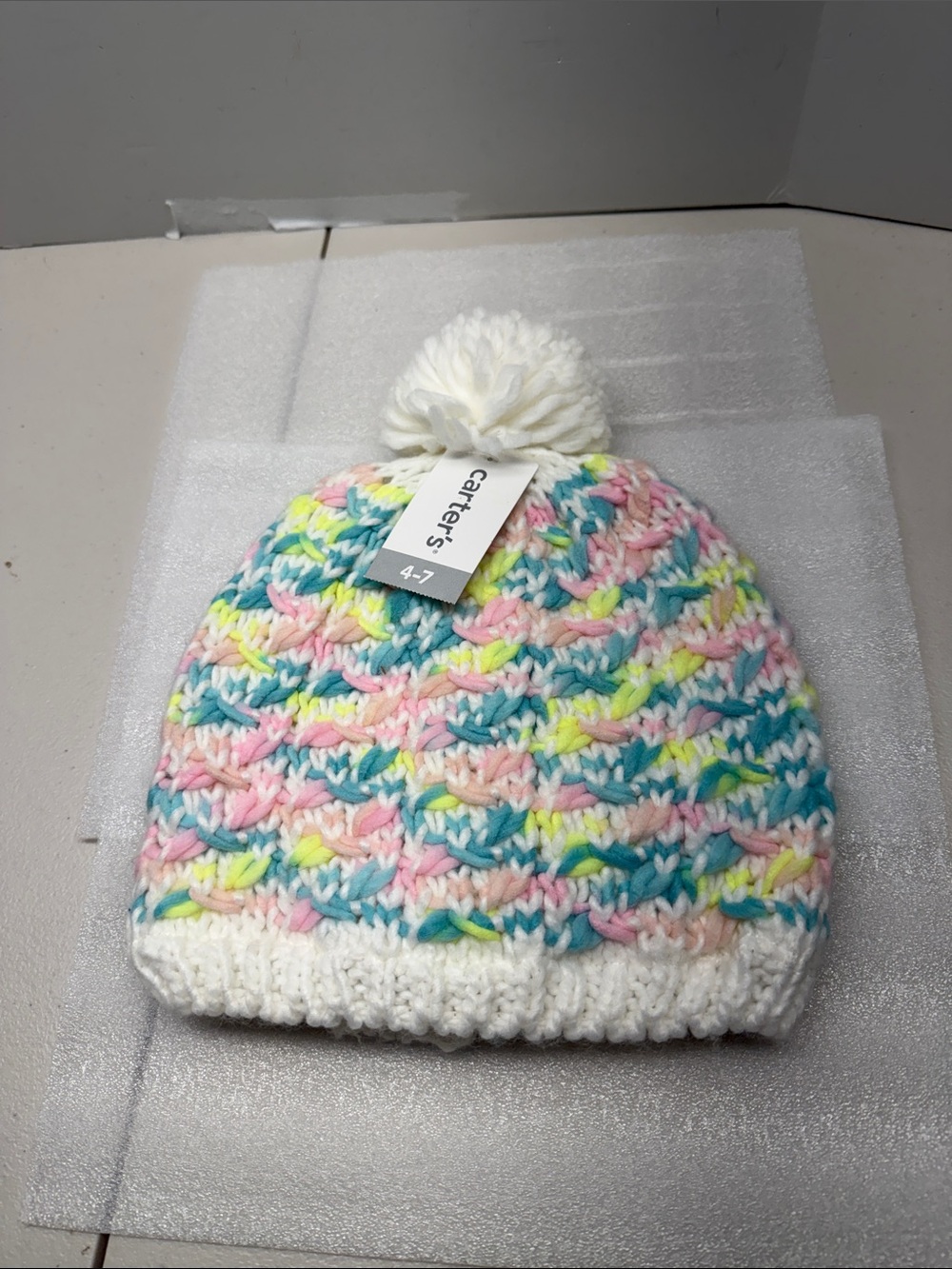 Carter's White Pom-Pom Beanie with Pastel Pink, Blue, Yellow and Mint Stripes